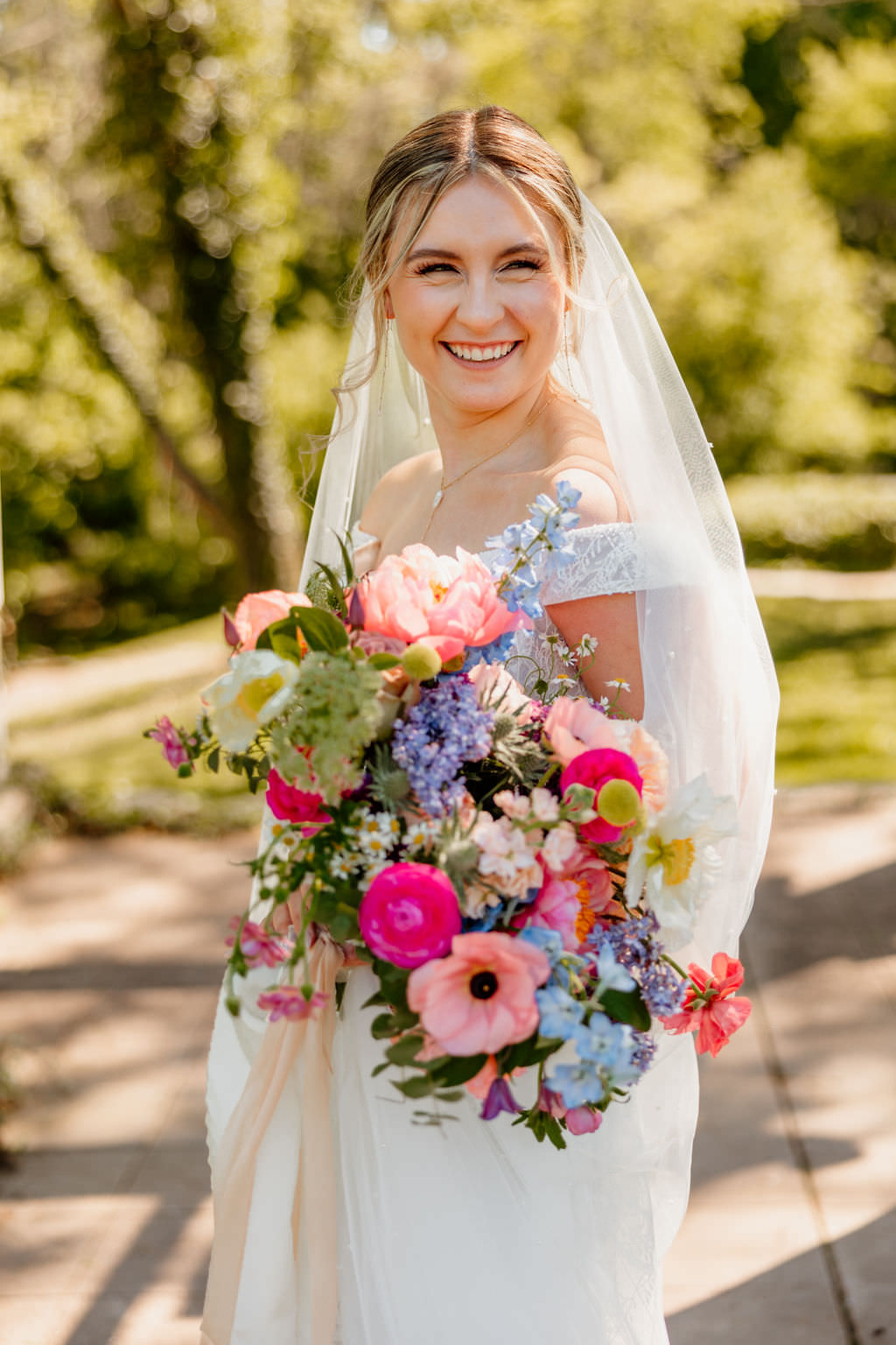 Bride smiling holding her bouquet at central PA wedding venue