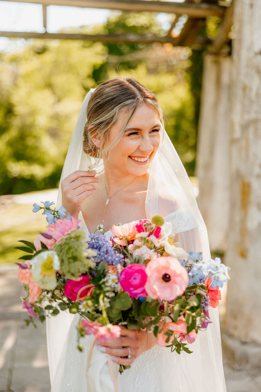Bride smiling holding her bouquet at central PA wedding venue